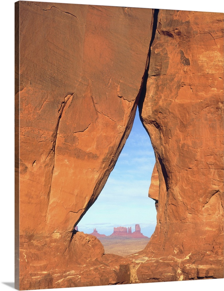 USA, Arizona. View of formations through famous Teardrop Window through rock face in Monument Valley.