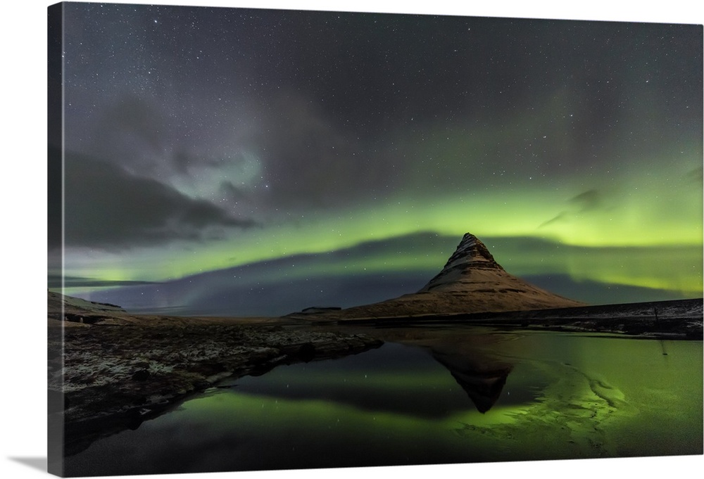 Aurora borealis reflects below Kirkjufell aka Church Mountain on the Snaefellsnes Peninsula in western Iceland.