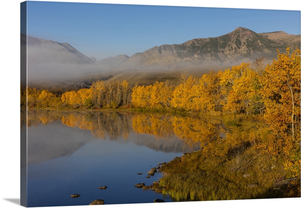Autumn color reflects into Maskinonge Lake in Waterton Lakes National Park, Alberta, Canada