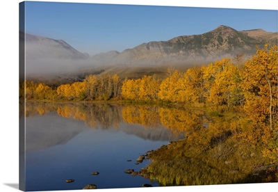 Autumn color reflects into Maskinonge Lake in Waterton Lakes National Park, Canada