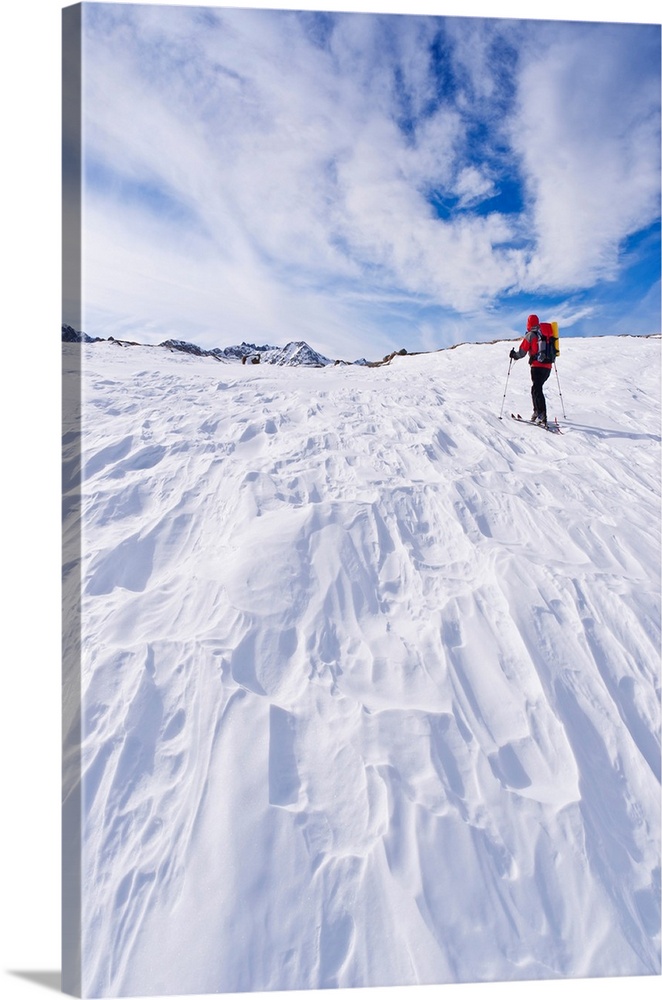 Backcountry skier under Piute Pass, John Muir Wilderness, Sierra Nevada Mountains, California USA.