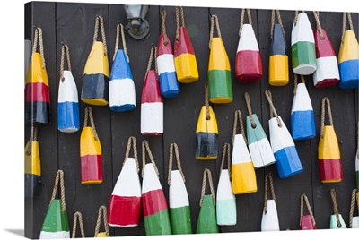 Bar Harbor, Maine, Colorful buoys for lobster traps hanging on wall
