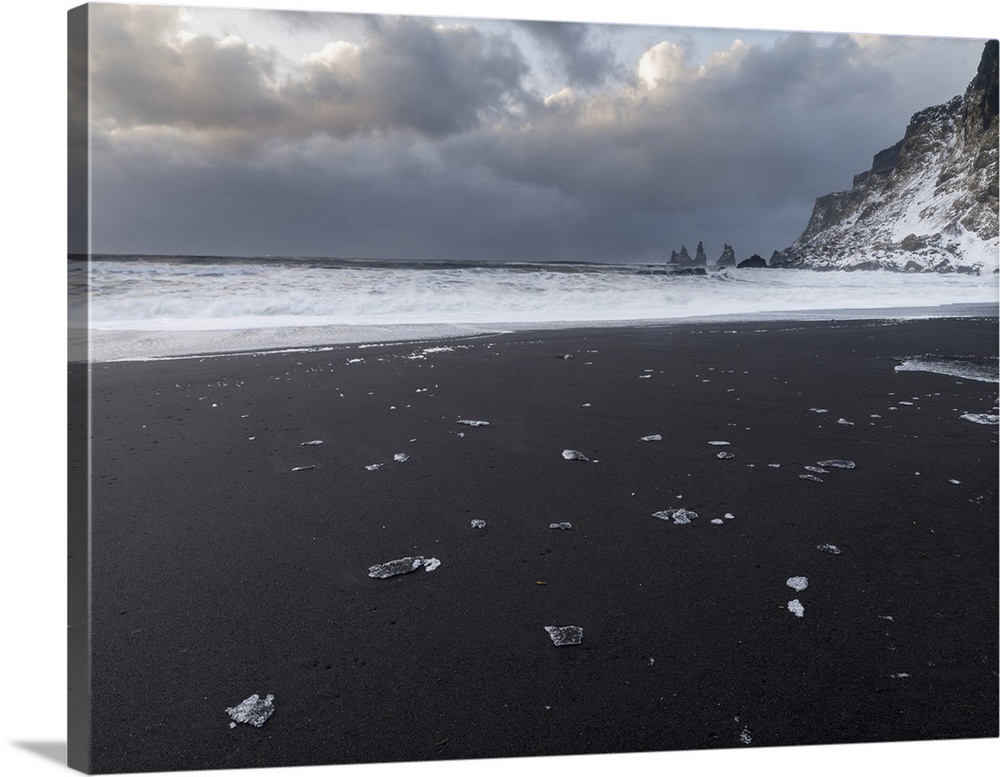 Coast near Vik i Myrdal during winter. Black volcanic beach with the Reynisdrangar sea stacks, Iceland.