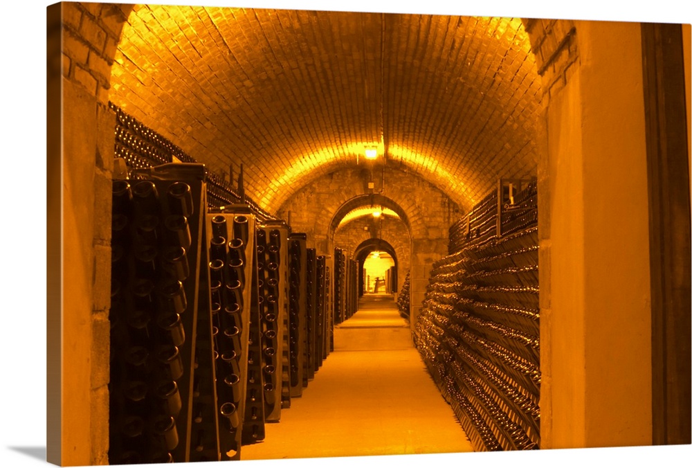 The underground wine cellar, thousands of bottles aging either in pupitres (racks) upside down waiting to be disgorged or ...