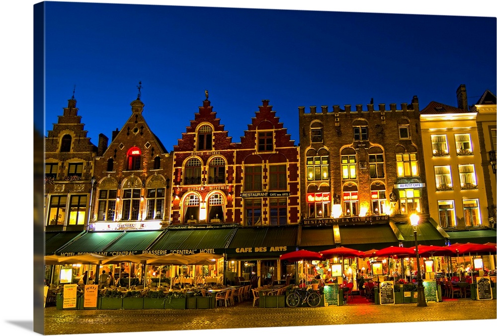 Belgium night photo of colorful cafes in Marketplace in downtown Bruges Belgium .