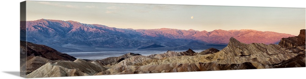 USA, California, Death Valley National Park, Panoramic view of moon setting at sunrise over Panamint Mountain Range