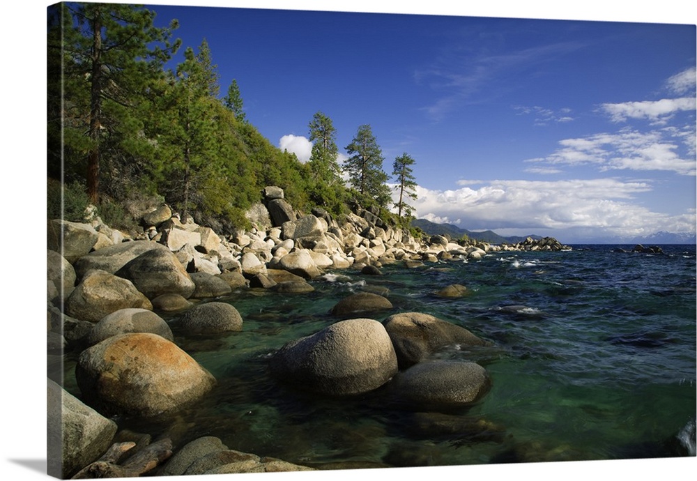 USA, California, Lake Tahoe. Smooth granite boulders line the lake shore in clear water.