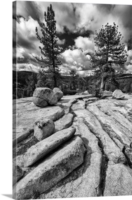 California, Yosemite National Park granite outcropping with boulders, clouds and trees