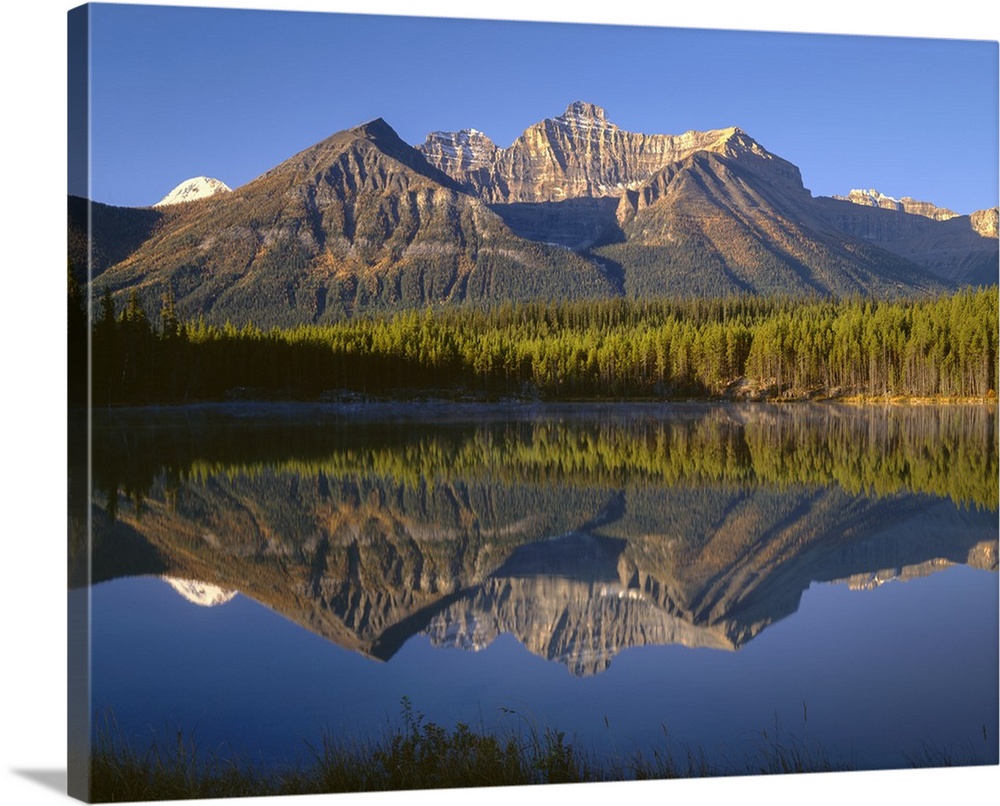 Canada, Alberta, Banff National Park, Early morning light on the Bow Range reflects in Herbert Lake..