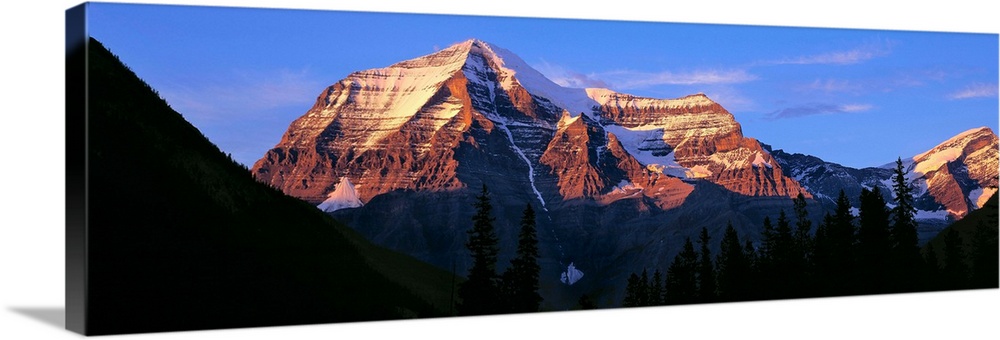 Canada, British Columbia, Mt Robson. The striation on Mount Robson, a World Heritage Site, is accentuated by the sunset li...