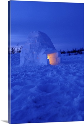Canada, Manitoba, Churchill. Arctic igloo with candle light inside