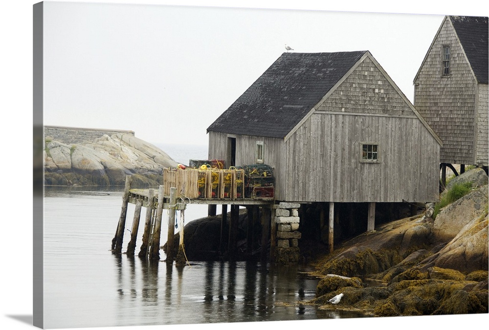 Canada, Nova Scotia, Peggy's Cove. Lobster traps on typical wooden dock.