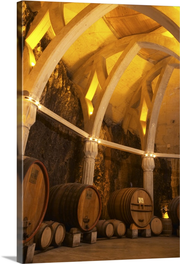 Big vats and the roof construction that gives associations to a cathedral carved in the rock.Pillars and arches.  Chateau ...