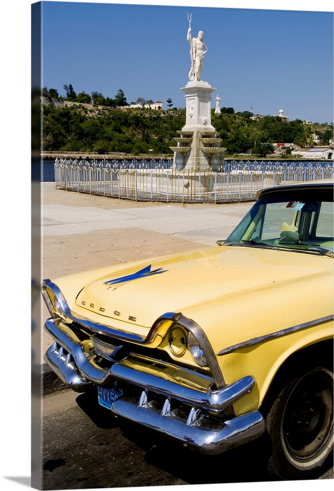Classic Dodge 50s auto in front of river and statues with Christ statue on hill in background in Havana Cuba Habana