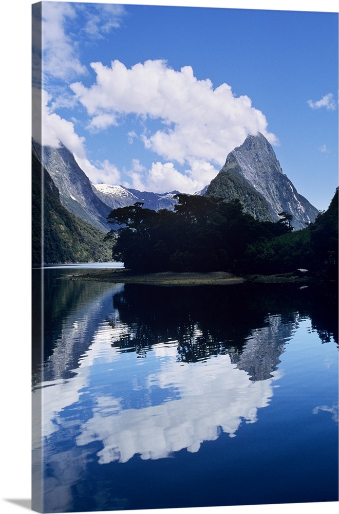 Cloud-capped Mitre Peak rises out of Milford Sound in Fiordland National Park, South Island, New Zealand.