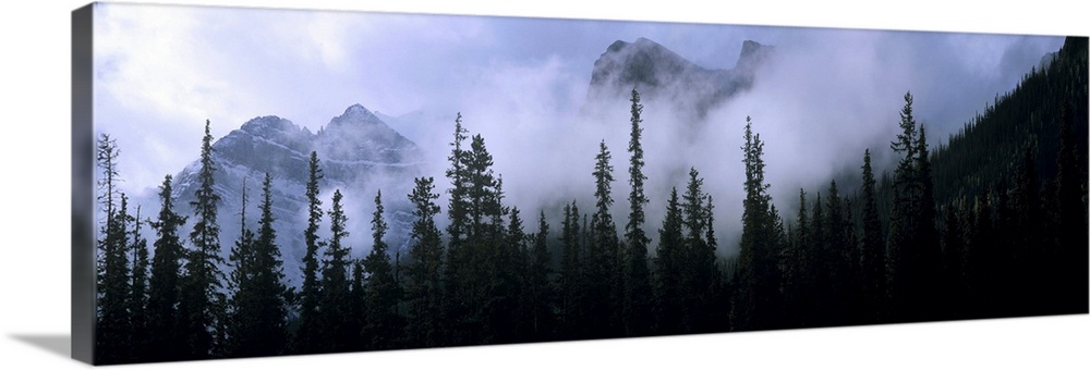 Canada, Alberta, Banff NP. Clouds swirl around mountain peaks above Lake Louise Junction in Banff NP, a World Heritage Sit...