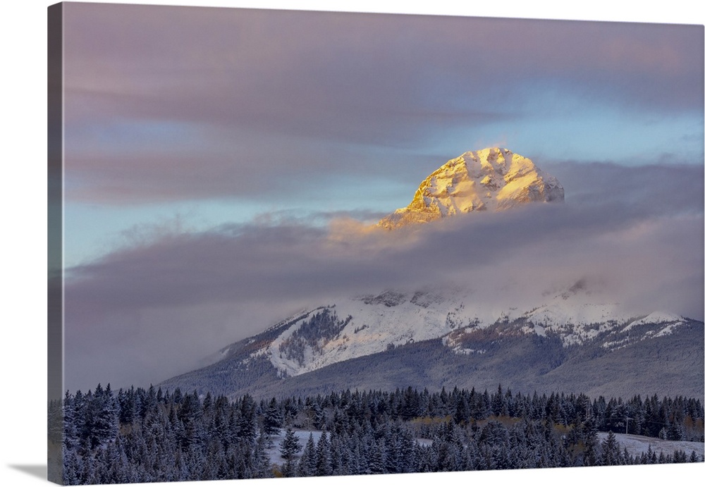 Clouds envelope Crowsnest Mountain at Crowsnest Pass, Alberta, Canada