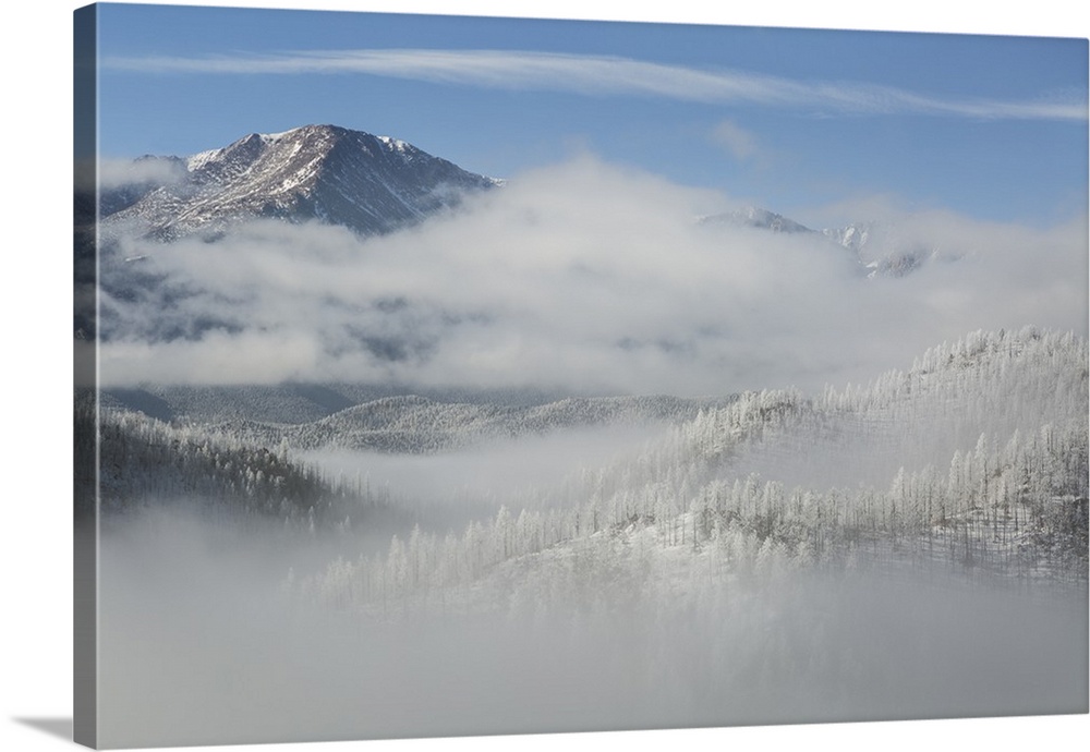 USA, Colorado. Clouds fill the valleys below Pikes Peak (14,109ft - 4301m) on a frosty winter morning in Colorado