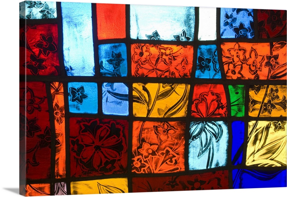 Colorful stained glass at a church with nature themes.