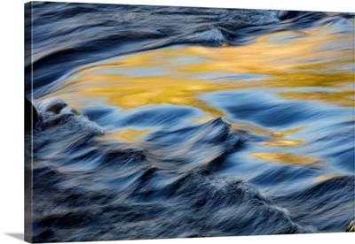 Colors reflected on flowing water, Firehole River, Yellowstone National Park
