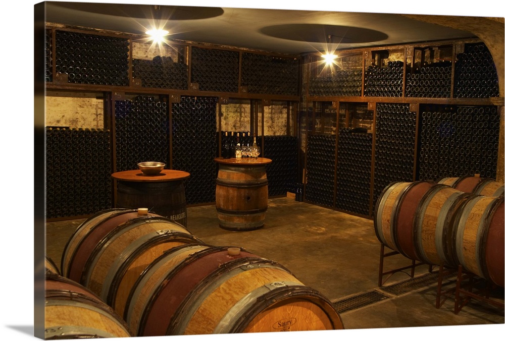 A corner in the cellar where older vintages are stored. Arranged as a tasting room with some barrels in the foreground.  C...