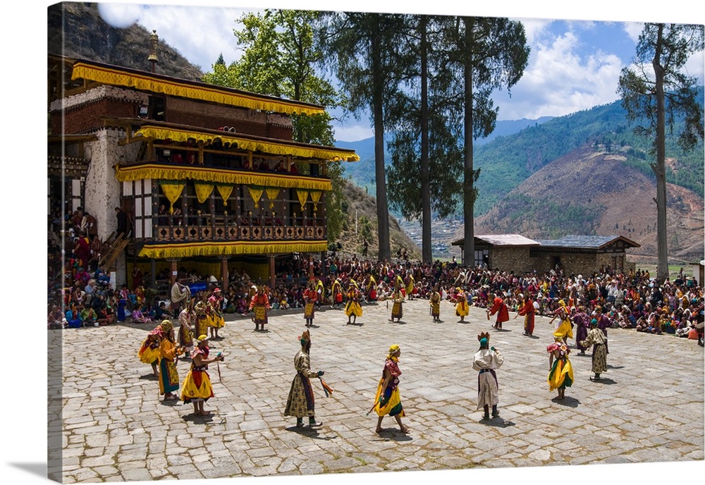 Costumed dancers at religious festivity with many visitors, Paro Tshechu, Bhutan.