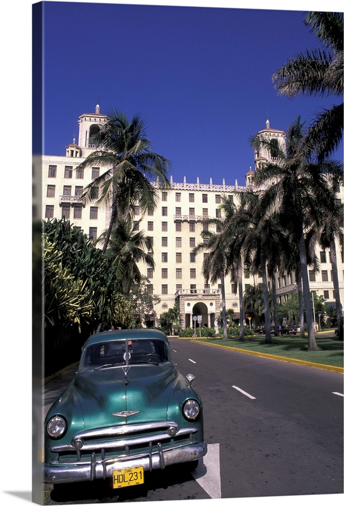 Cuba, Havana.  Classic 1950's auto in front of Habana Nacional Hotel.