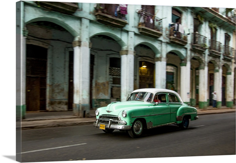 Cuba, Havana, classic green car and arches of colonial building. .