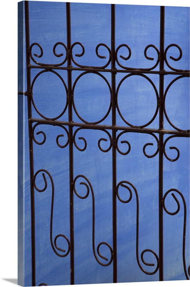 Cuba, Vinales, wrought iron gate and blue wall.