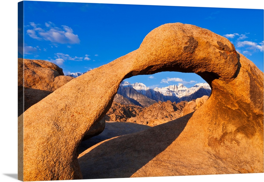 Dawn light on Mount Whitney through Mobius Arch, Alabama Hills, Inyo National Forest, California USA.