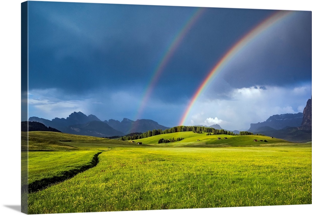 Italy, Dolomites, Alpi di Siusi. Double rainbow over mountain meadow. Credit: Jim Nilsen