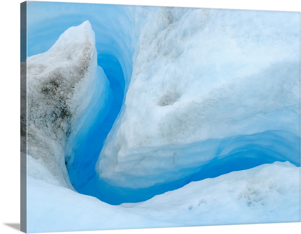 Drainage system on the surface of the ice sheet. The brown sediment on the ice is created by the rapid melting of the ice....