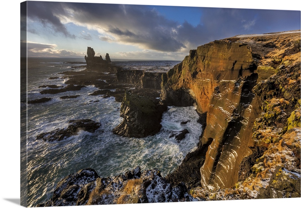 Dramatic cliffs at Londrangar sea stacks in the North Atlantic ocean on the Snaefellsnes peninsula in western Iceland.