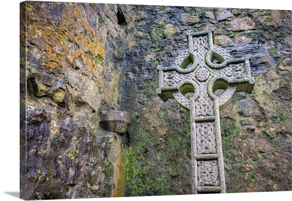 Elaborate Celtic cross marks a grave at a historic Irish church, County Mayo, Ireland.