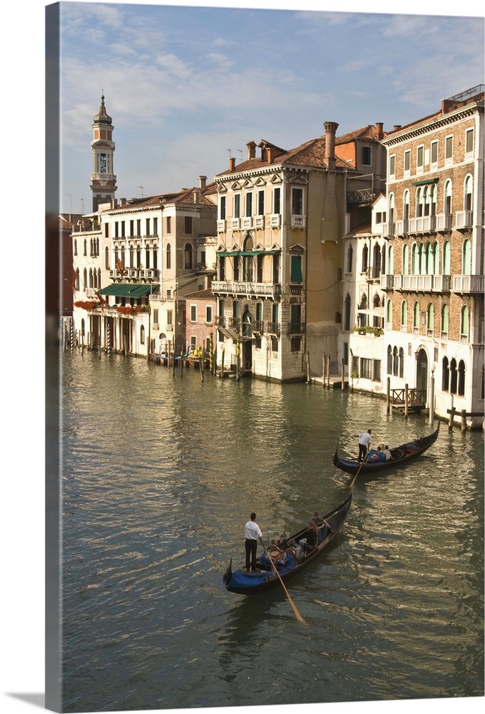 Europe, Italy, Venice. Tourists enjoy a gondola ride along the Grand Canal in Venice