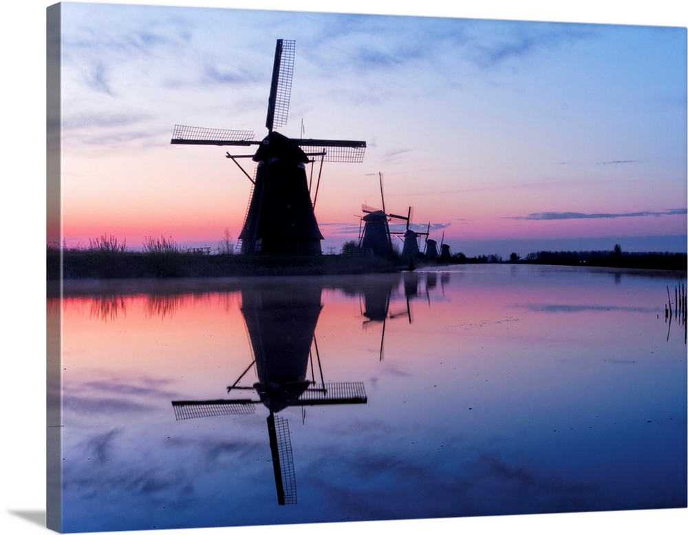 Europe, Netherlands, Kinderdijk, Windmills at Sunrise along the canals of Kinderdijk.