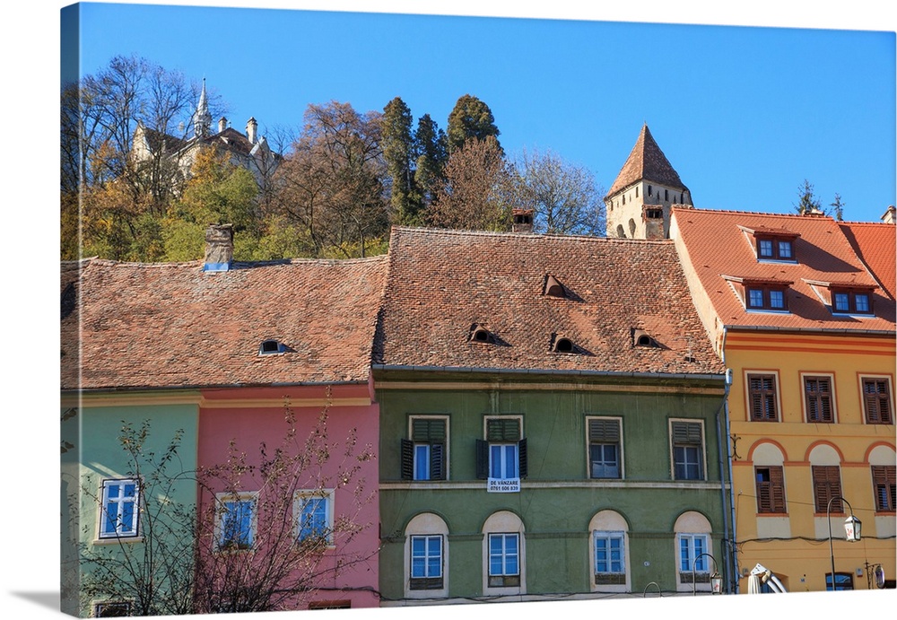 Europe, Transylvania, Romania, Mures County, Sighisoara, colorful residences along street in medieval village. UNESCO Worl...