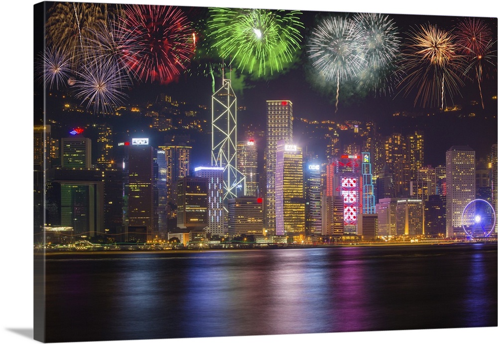 China, Hong Kong. Fireworks over city at night.