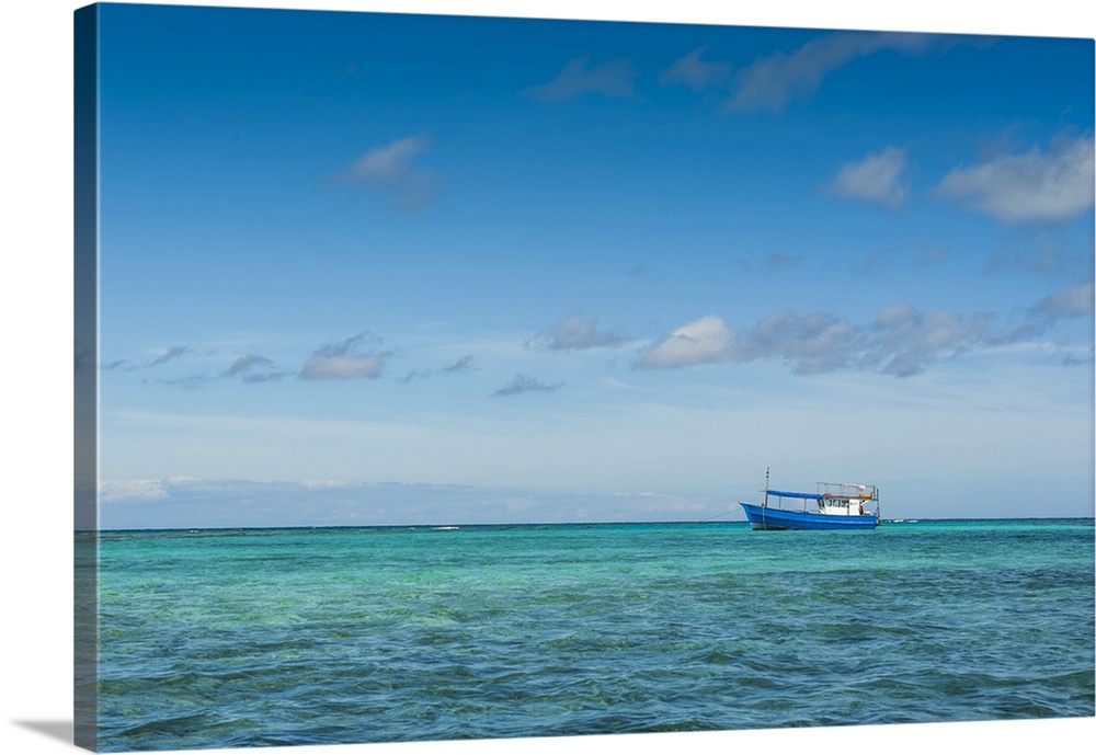 Fishing boat in the turquoise waters of the blue lagoon, Yasawa, Fiji, South Pacific.