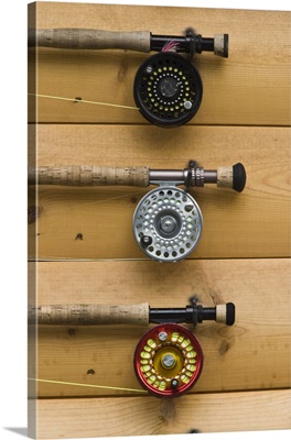 Fishing rods wait for customers on the wall of the lodge