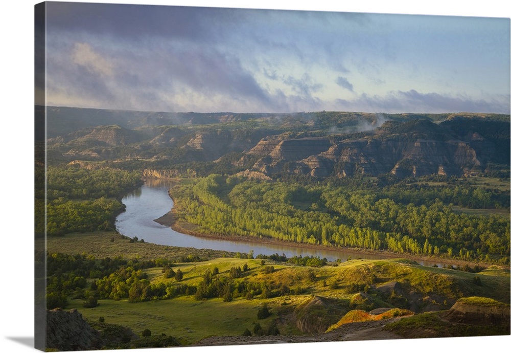 Fog burns off at sunrise from River Bend Overlook in the North Unit of Theodore Roosevelt National Park, North Dakota, USA