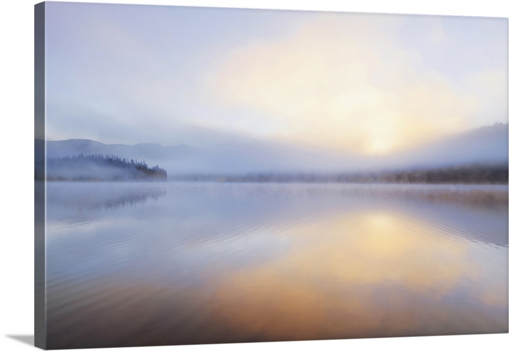 Foggy sunrise over Beaver Lake in the Stillwater State Forest near Whitefish, Montana, USA