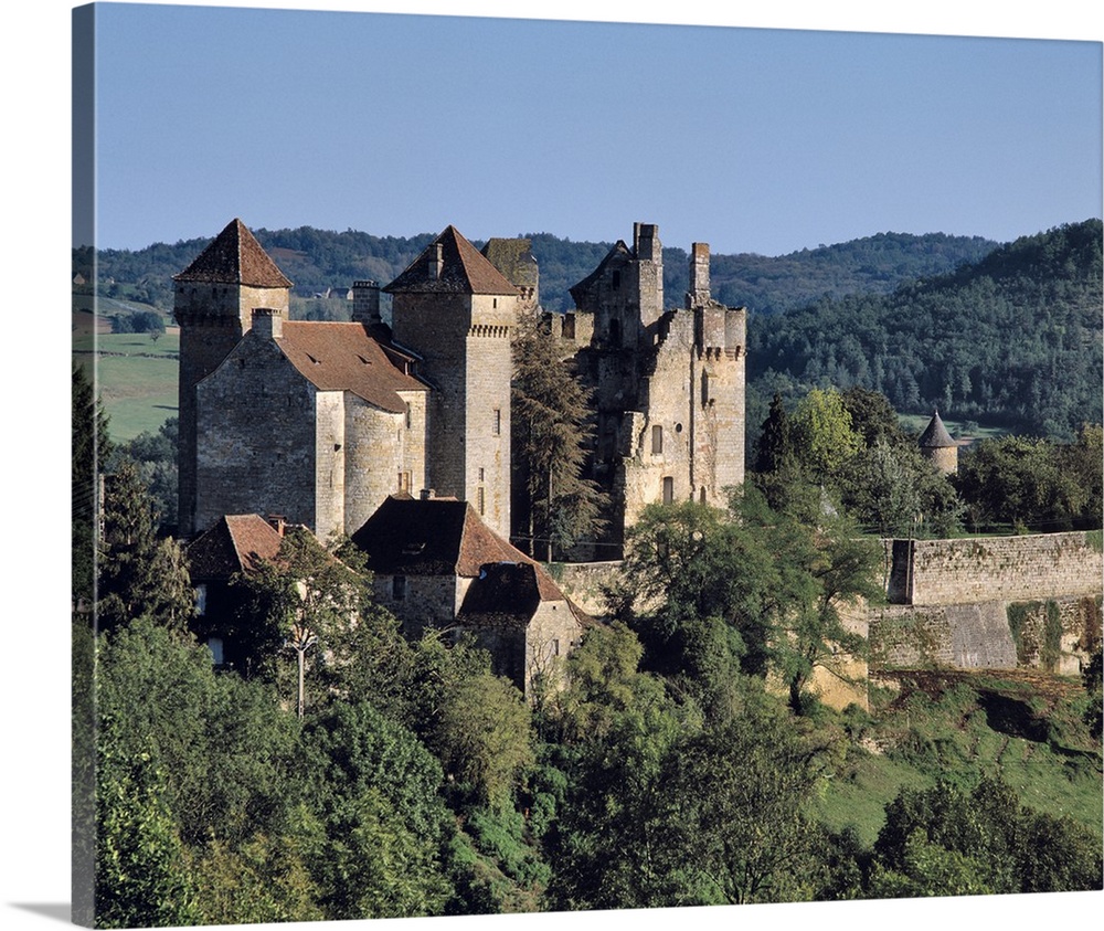 Europe, France, Curemonte. The towers of Curemonte Castle catch the late afternoon light in the Limousin Region of France.