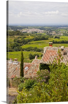 France, Provence, Seguret. View of countryside above tiled rooftops