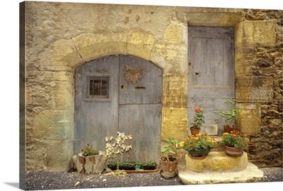 France, St Come d'Oit, stone building with potted plants in front