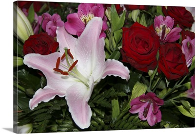 Full frame of flower arrangement including red roses and a Rubrum Lily