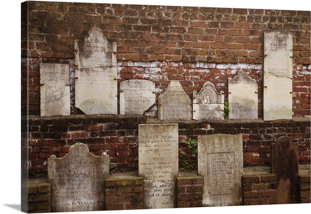 North America, USA, Georgia, Savannah, Tombstones on a wall in Historic Colonial Park Cemetery.