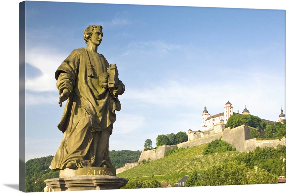Germany, Bavaria, Bayern, Wurzburg. Festung Marienberg fortress and Old Main River Bridge statue.