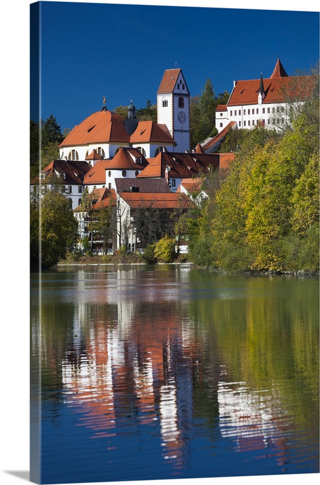 Germany, Bavaria, Fussen, St. Mang Abbey and the Hohes Schloss Castle from the Lech River.