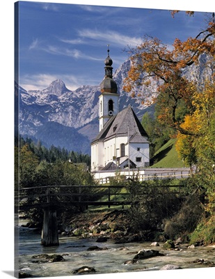Germany, Ramsau. The Ramsauer Ache flows by church